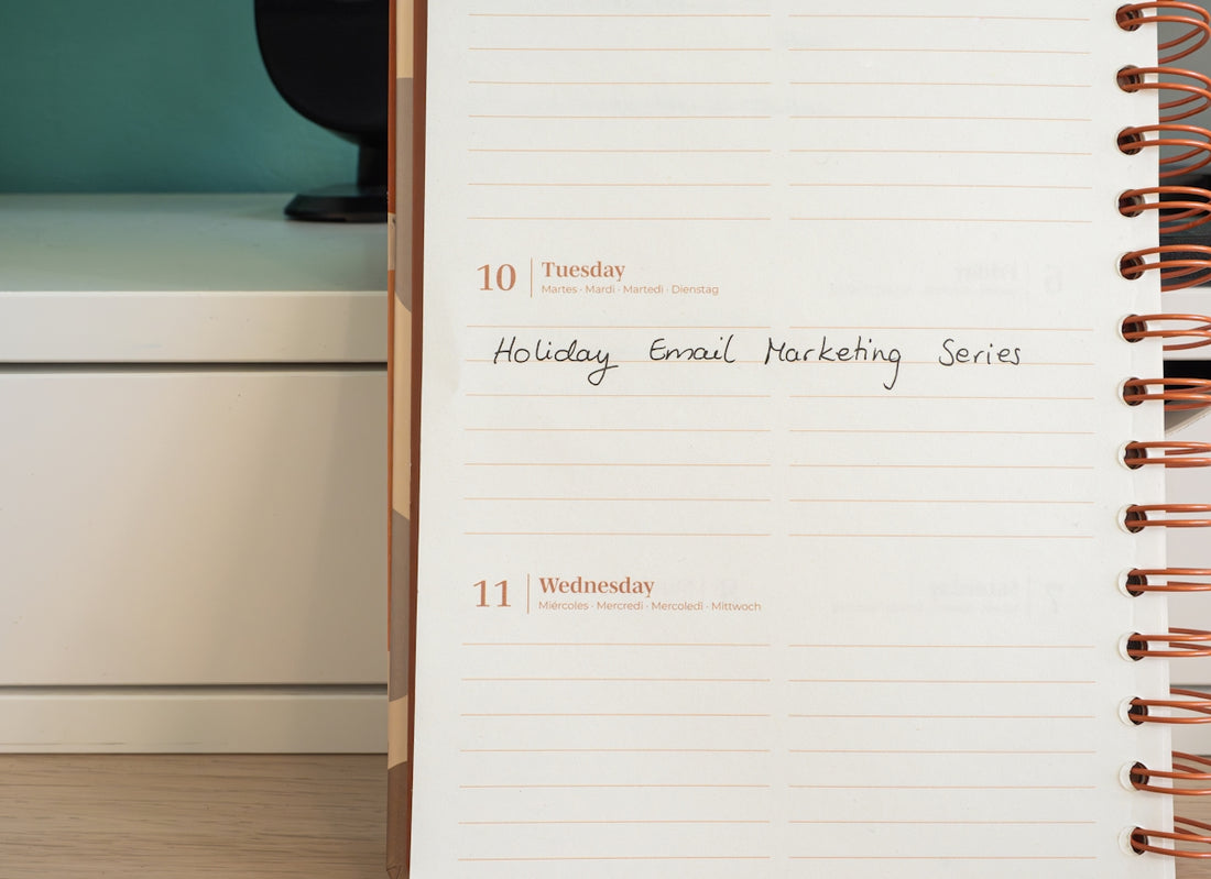 a notepad with the words holiday email marketing series written on it